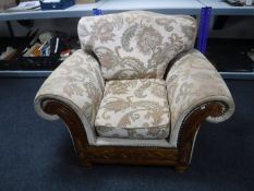 A wood framed armchair upholstered in a floral fabric
