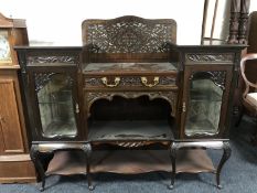 A Victorian mahogany chiffonier with a fret work panel