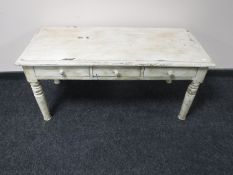 A painted shabby chic coffee table fitted with three drawers