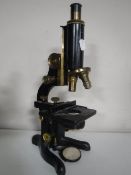 A Watson of London service microscope in brass and lacquered metal