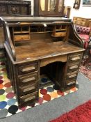 An oak roll-topped double pedestal desk,