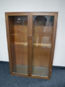 A mid 20th century teak glazed door bookcase