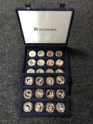 A blue fitted coin case containing twenty four Fifty Pence commemorative coins - Diamond Jubilee