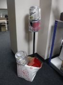 A Gum Ball dispenser on stand with two boxes of Gum Ball dispenser parts