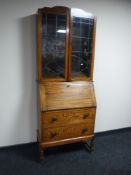An early 20th century oak bureau bookcase