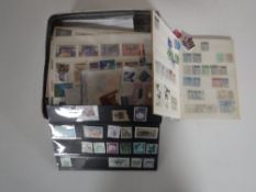 A tin containing Stanley Gibbons stamp book, loose stamps.