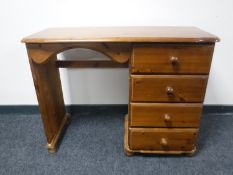A contemporary pine dressing table fitted four drawers