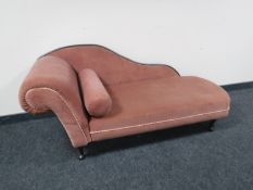 A chaise longue upholstered in pink dralon