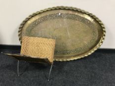 A large eastern brass tray together with a metal and wicker folding magazine rack