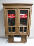 An Edwardian oak wall mounted smoker's cabinet bearing 