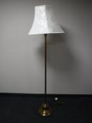 A brass Corinthian column standard lamp with shade