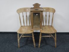 A pair of pine farmhouse kitchen chairs and a pine glazed door cabinet