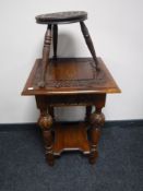A heavily carved early 20th century occasional table and a milking stool