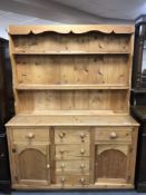 A stripped pine kitchen dresser
