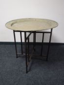 A folding Eastern brass topped table