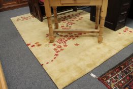 An Indian hand tufted carpet on golden ground with star decoration,