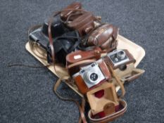 A tray of eight vintage cameras in leather cases including Paxette Zennit etc