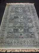 A machine made fringed Persian rug on turquoise ground