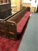 An early 20th century stained pine church pew, numbered 93,