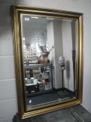 A black and gilt framed mirror