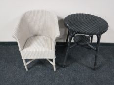 A Lloyd loom basket chair and an occasional table