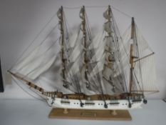 A wooden model of a four masted baroque sailing ship on stand