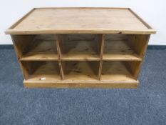 A pine tray table fitted with shelves beneath