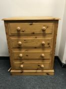 A contemporary pine four drawer chest