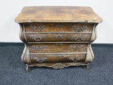 A late nineteenth century walnut four drawer chest on paw feet.
