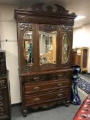 An Edwardian mirror doored press fitted with five drawers below,