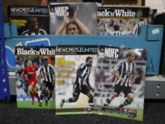 A box containing a large quantity of Newcastle United home football programmes,