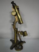 An antique R & J Beck brass microscope (parts missing)