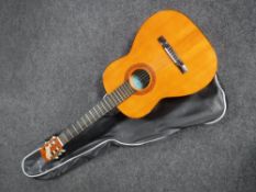 A Vittoro acoustic guitar distributed by Boosey & Hawkes in carry bag