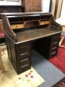 An oak roll-topped double pedestal desk,