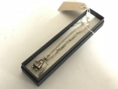 A silver bracelet with clown charm