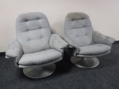 A pair of mid 20th century armchairs in button fabric on metal bases