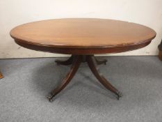An oval inlaid mahogany pedestal coffee table