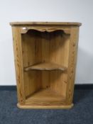 A set of pine hanging corner shelves