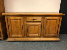 A Barker & Stonehouse triple door sideboard,