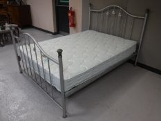 A 4'6 metal bed frame with Silentnight mattress