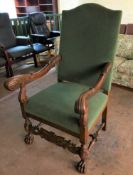 An early twentieth century heavily carved scroll arm,