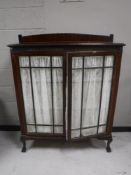 A Victorian mahogany double door display cabinet on claw and ball feet