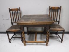 An oak pull out dining table and two chairs