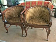A pair of beech and wicker armchairs