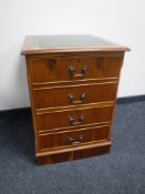 A yew wood two drawer filing chest with an inset green leather panel