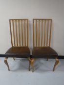 A pair of continental oak rail back dining chairs