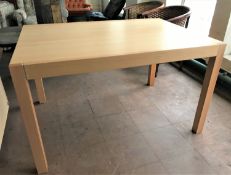 A contemporary pine effect dining table