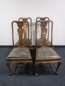 A set of four Victorian carved oak dining chairs