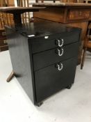 A black ash three drawer under desk chest
