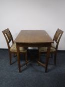 An early 20th century continental dining table and two chairs